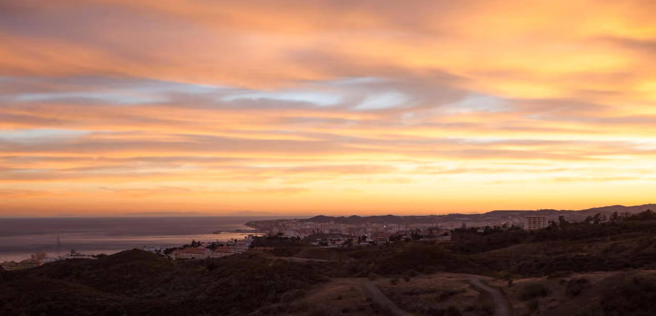Elevated sunset panorama over Fuengirola's coastline, town and Mediterranean Sea viewed from the hills above Torreblanca, Costa del Sol, Spain, shown as local context near BOUGAIVILLEA ROSA