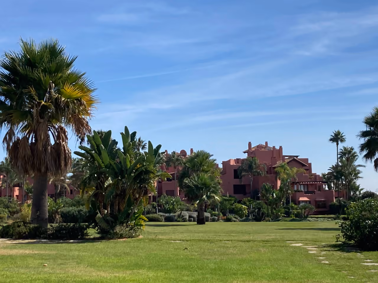 Zdjęcie okolicy w pobliżu CAPRI - FASE 2 przedstawiające terakotowe wille mieszkalne z tropikalną i śródziemnomorską zielenią w Estepona, Costa del Sol